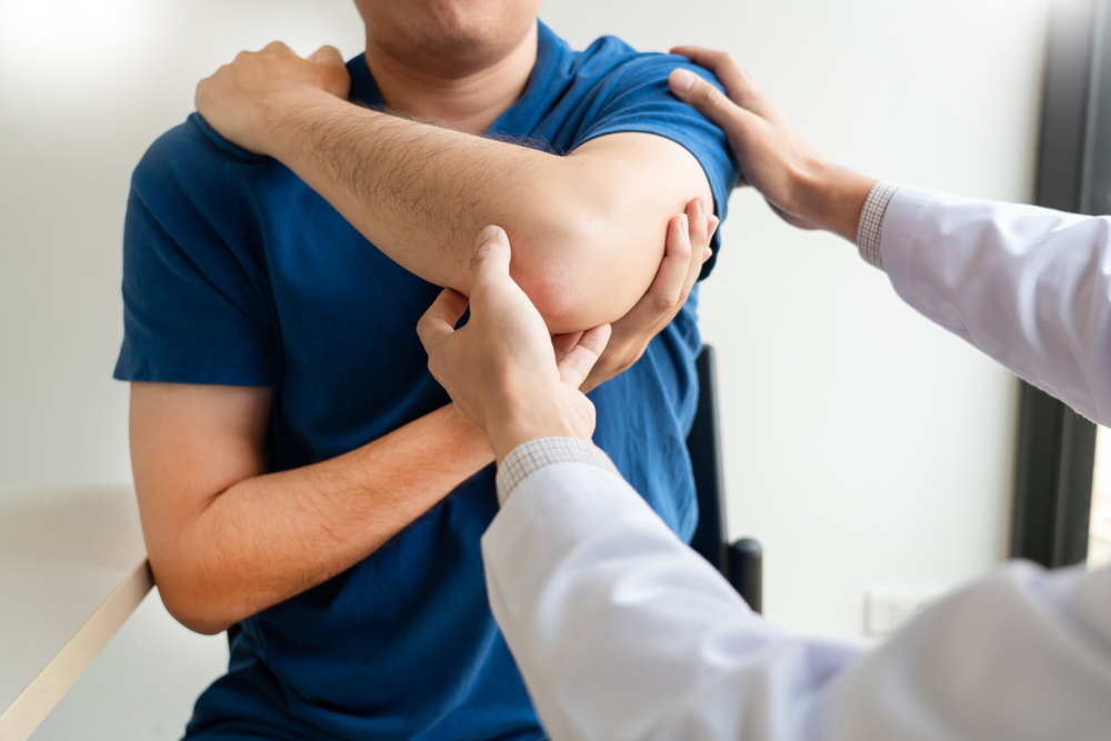 A physiotherapist supporting a patient's arm